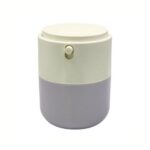 A 50ml white airless jar with a press-down dispensing top, showing a small amount of cream