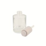 A sleek 1.69 oz (50 ml) clear glass cylinder bottle with a metallic silver press-button dropper cap. The heavy-base glass design conveys a sense of high-end quality and clinical precision.