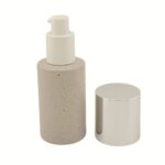 A 1.69 oz (50 ml) clear glass Boston Round bottle with big overcap featuring a sleek black treatment pump. The classic curved-shoulder design highlights a professional and timeless packaging solution for premium skincare brands.