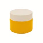 A yellow 1.69 oz straight-sided glass jar with a black smooth screw-top lid.