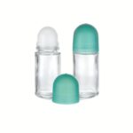 A 50 ml clear glass cylindrical bottle with a metallic rollerball tip and a black minimalist screw-on cap.